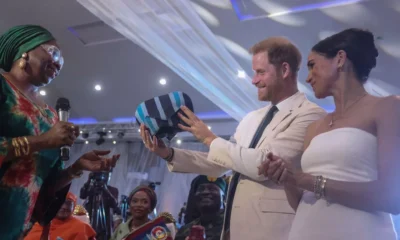 Prince Harry and Meghan Markle beam with delight as they receive traditional Nigerian gift