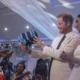 Prince Harry and Meghan Markle beam with delight as they receive traditional Nigerian gift