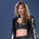 Taylor Swift flashes her toned abs in a shimmering black crop top and hot pants as she takes to the stage for third night in Paris on her iconic Eras Tour